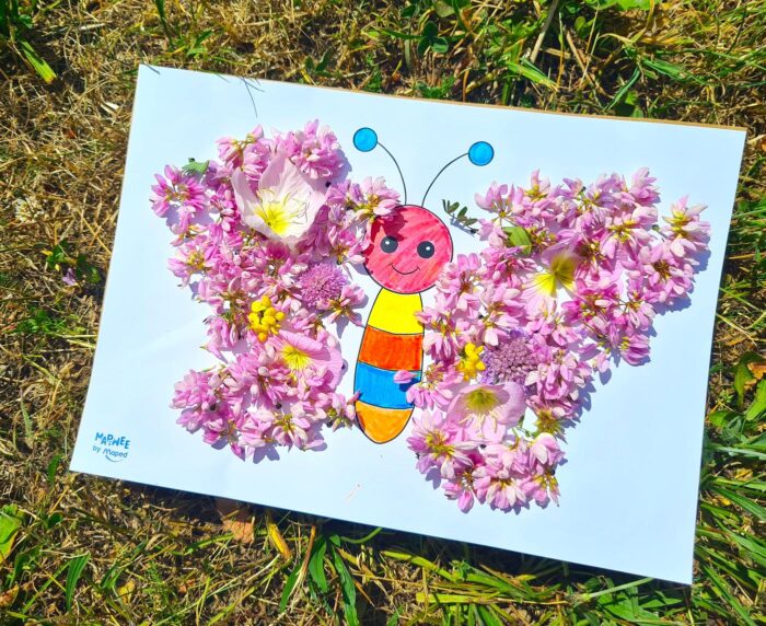 Papillon terminé aux ailes de fleurs roses, tableau floral en fleurs réalisé par un enfant